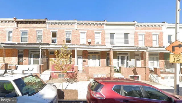 a view of a house with a backyard porch and sitting area