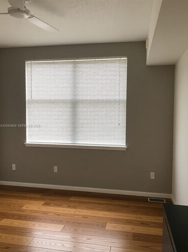 17145 North Bay Road Sunny Isles Beach, FL 33160 - Photo 2 of 6 a view of an empty room with wooden floor and a window