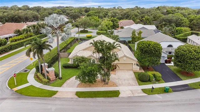 an aerial view of a house with garden space and street view