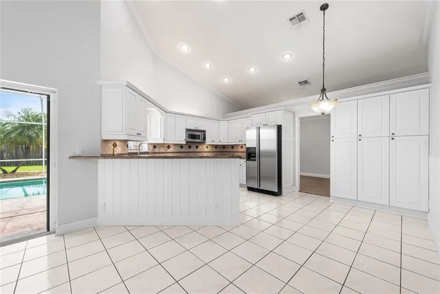 a kitchen with stainless steel appliances granite countertop a refrigerator and a sink