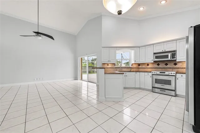 a kitchen with stainless steel appliances a refrigerator sink and microwave