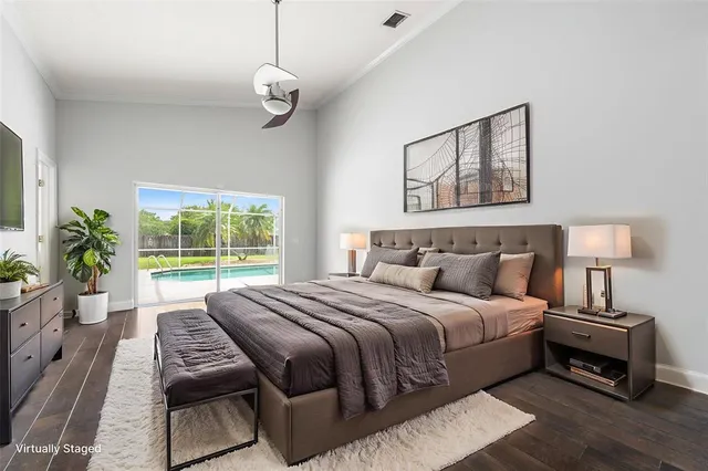 a bedroom with bed and wooden floor