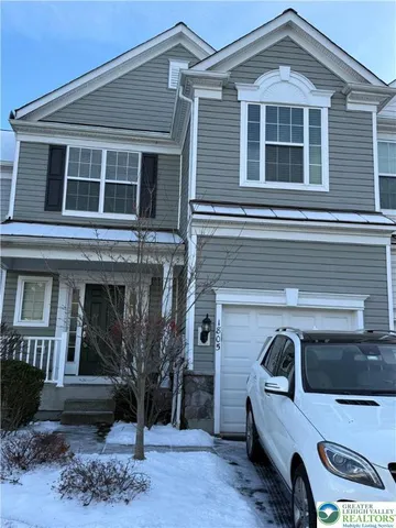 a front view of a house with parking space
