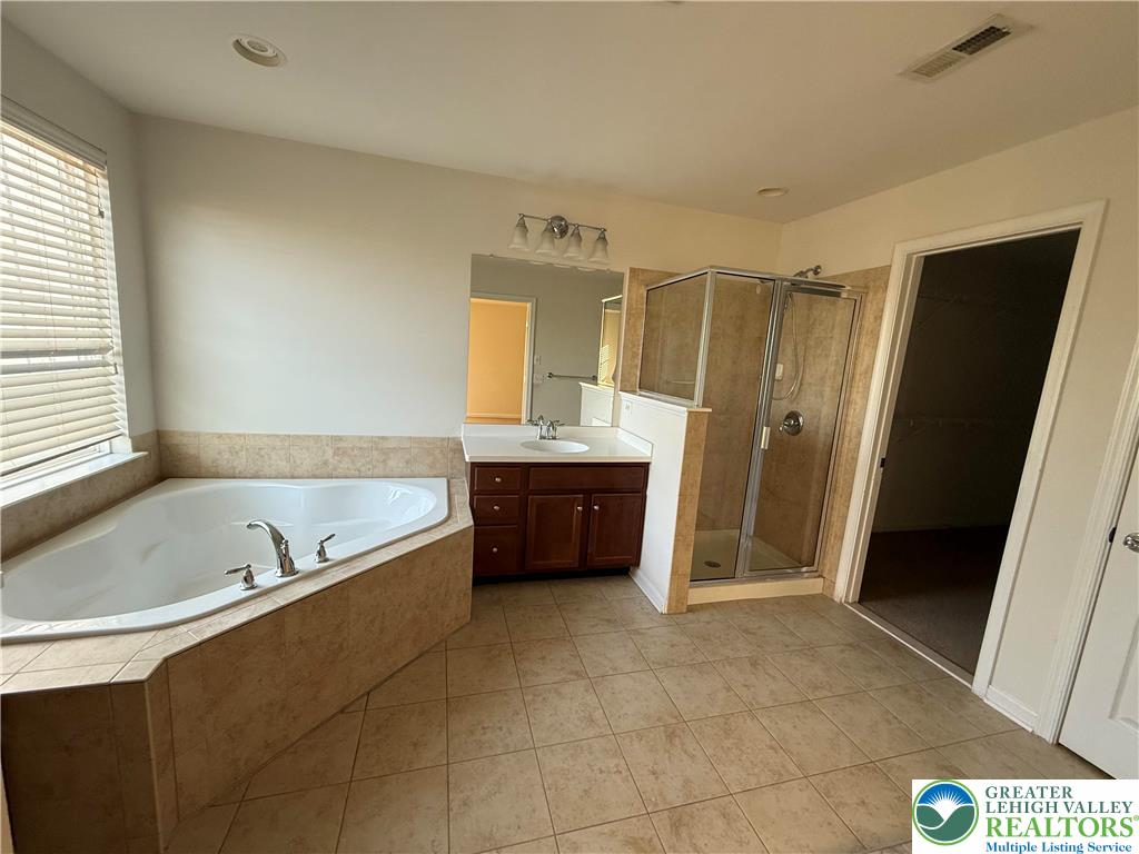 1805 Hemming Way Orefield, PA 18069 - Photo 7 of 24 a bathroom with a tub sink and a mirror