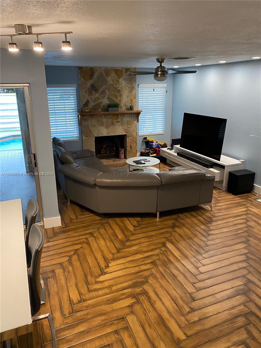 14530 Southwest 142nd Pl Circle Miami, FL 33186 - Photo 11 of 28 a living room with furniture and a fireplace