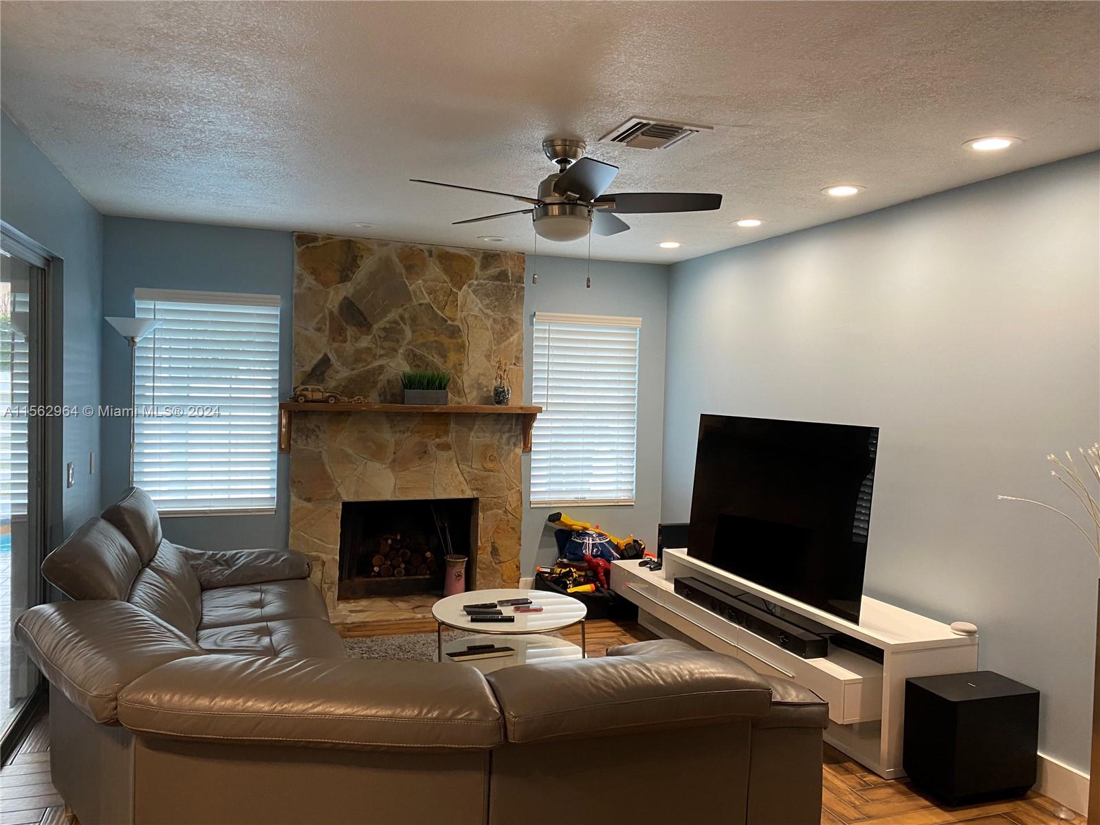 14530 Southwest 142nd Pl Circle Miami, FL 33186 - Photo 13 of 28 a living room with furniture and a fireplace