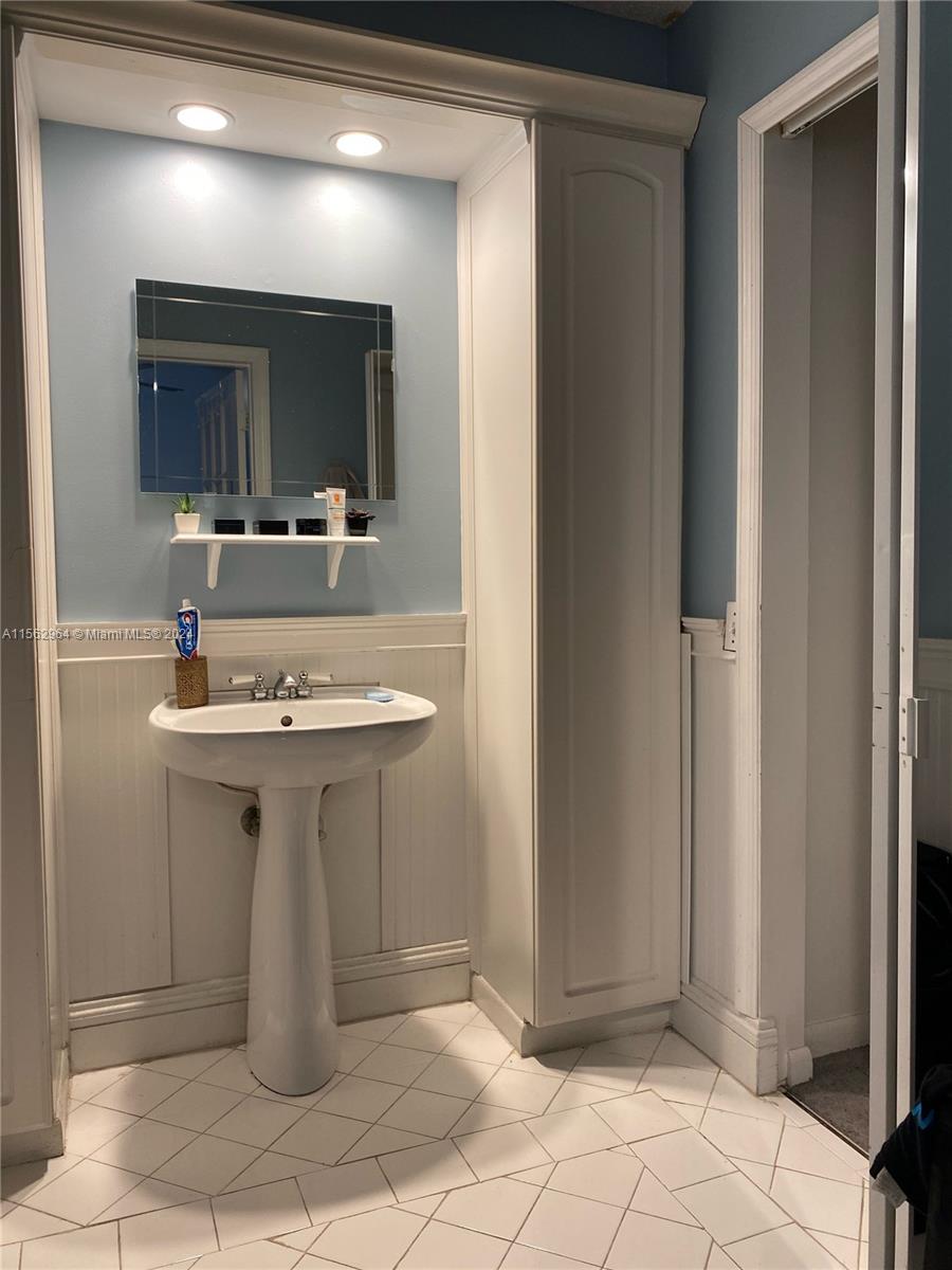 14530 Southwest 142nd Pl Circle Miami, FL 33186 - Photo 17 of 28 a bathroom with a sink and a mirror