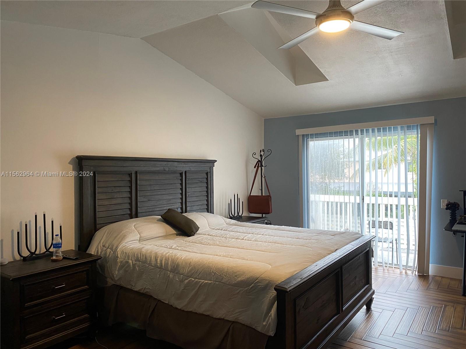 14530 Southwest 142nd Pl Circle Miami, FL 33186 - Photo 18 of 28 a bedroom with a bed and a large window