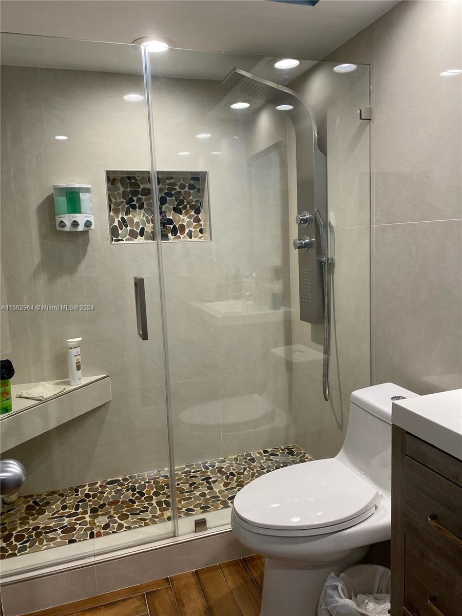 14530 Southwest 142nd Pl Circle Miami, FL 33186 - Photo 19 of 28 a bathroom with a toilet sink and shower