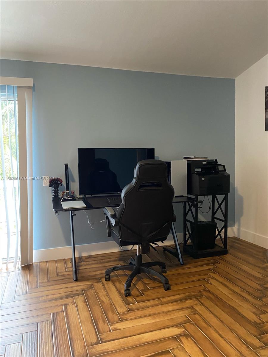 14530 Southwest 142nd Pl Circle Miami, FL 33186 - Photo 21 of 28 a workspace with furniture and wooden floor
