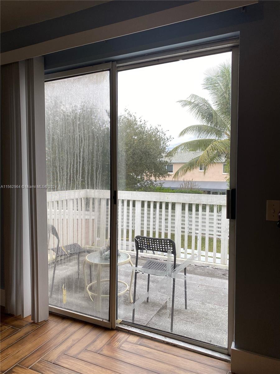 14530 Southwest 142nd Pl Circle Miami, FL 33186 - Photo 25 of 28 a view of a glass door with a floor to ceiling window