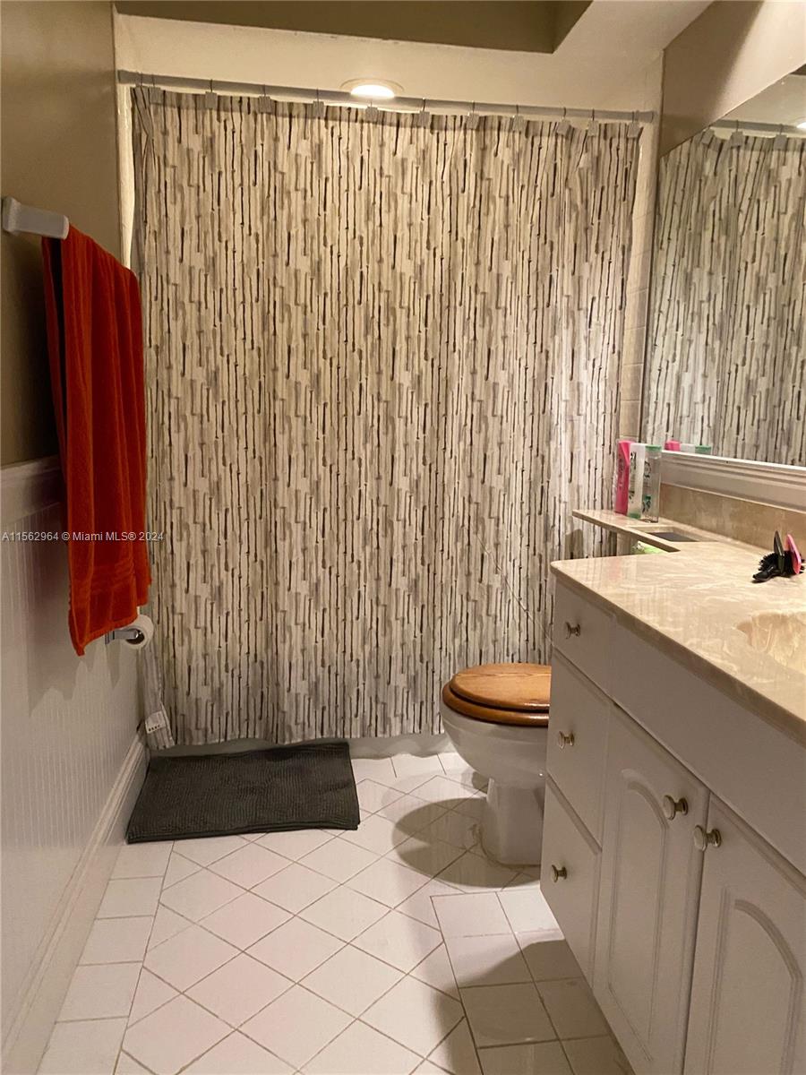 14530 Southwest 142nd Pl Circle Miami, FL 33186 - Photo 26 of 28 a bathroom with a sink and a mirror
