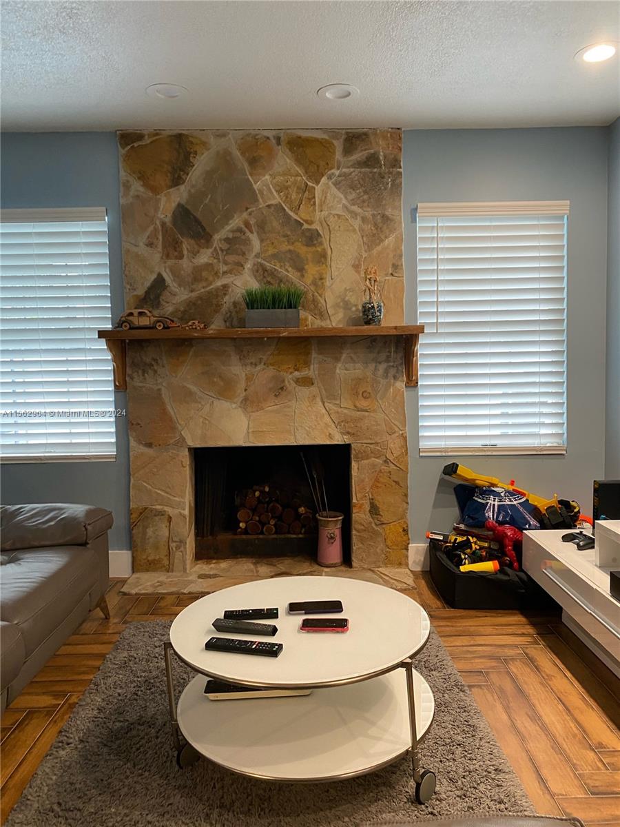 14530 Southwest 142nd Pl Circle Miami, FL 33186 - Photo 5 of 28 a living room with furniture and a fireplace