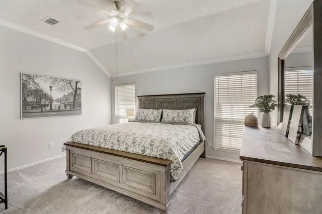 a bedroom with a bed and ceiling fan