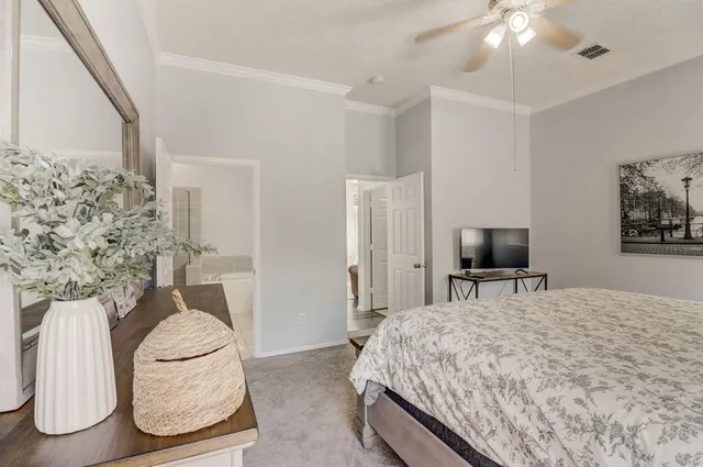 a bedroom with a bed and flat screen tv