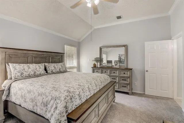 a bedroom with a large bed and a chandelier