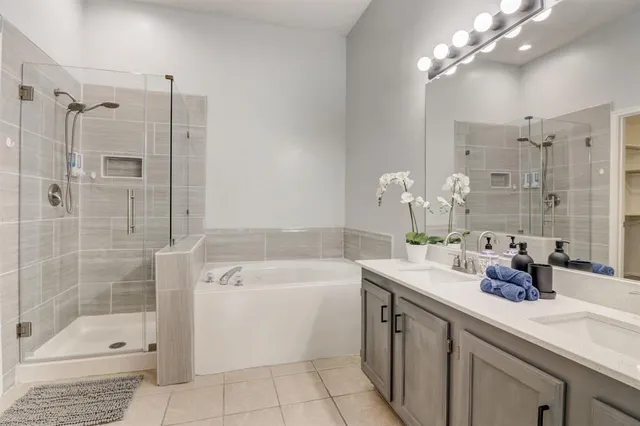 a bathroom with a sink a toilet a shower and a mirror