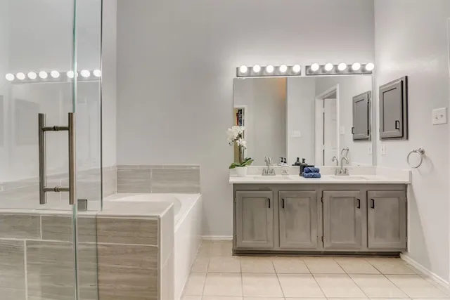 a bathroom with a sink a large mirror and a shower