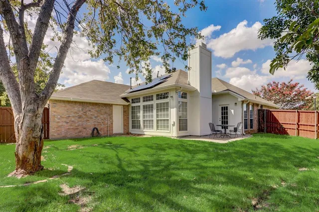 a view of a house with a yard and sitting area