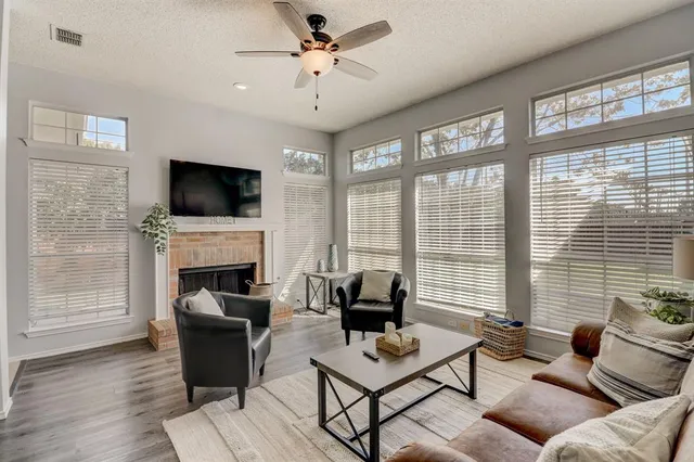 a living room with furniture a fireplace and a flat screen tv
