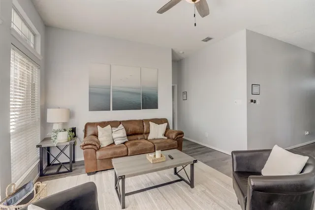 a living room with furniture and a lamp