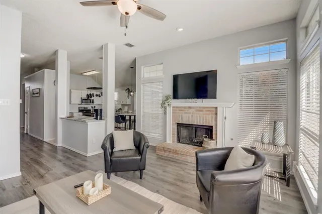 a living room with furniture and a fireplace