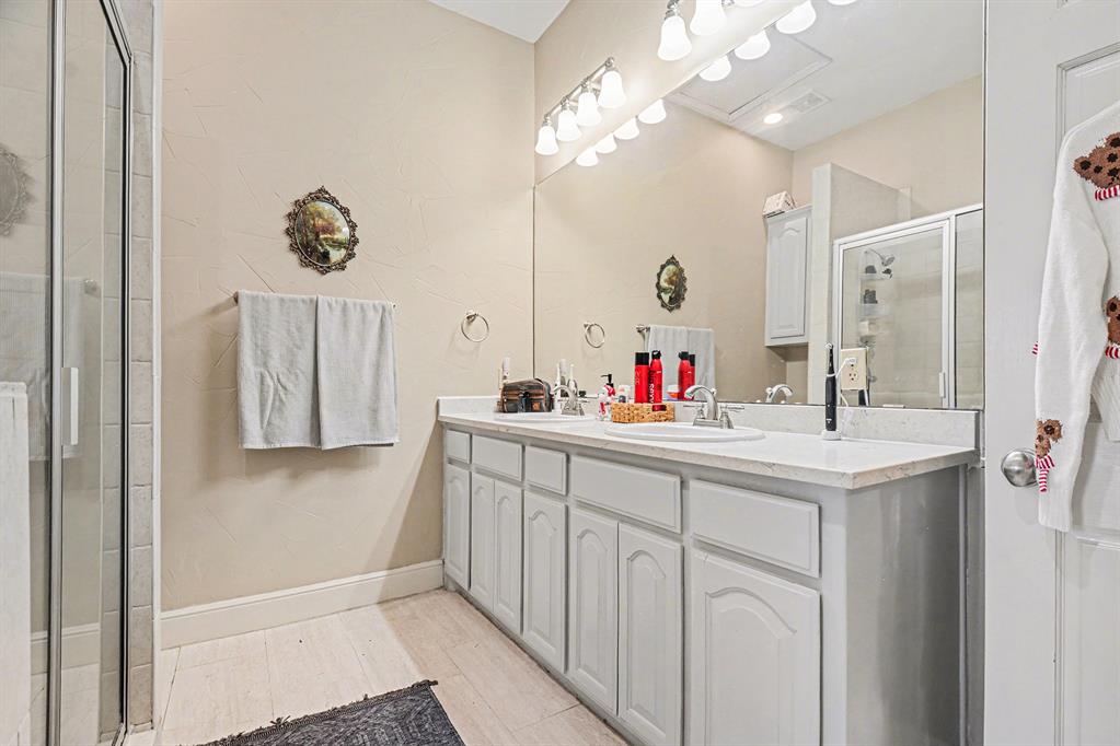 2474 McConnell Road Gunter, TX 75058 - Photo 13 of 17 a bathroom with a sink vanity and a mirror