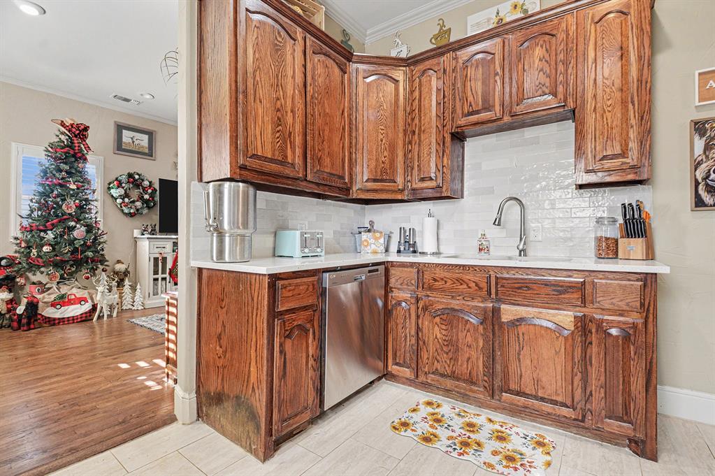 2474 McConnell Road Gunter, TX 75058 - Photo 4 of 17 a kitchen with stainless steel appliances granite countertop a sink and cabinets