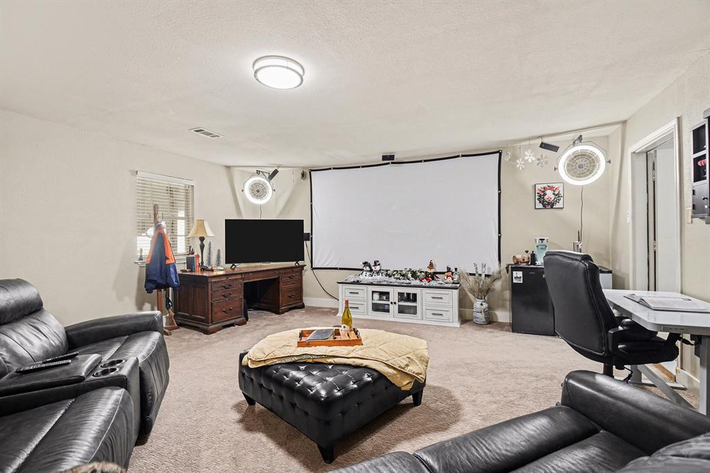 2474 McConnell Road Gunter, TX 75058 - Photo 6 of 17 a living room with furniture and a flat screen tv