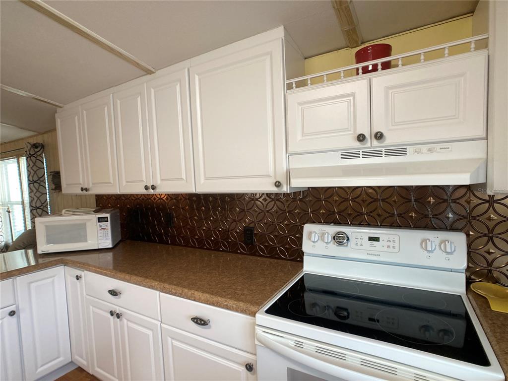 1710 7th Street Southwest, Unit 24 Ruskin, FL 33570 - Photo 11 of 44 a kitchen with white cabinets and appliances
