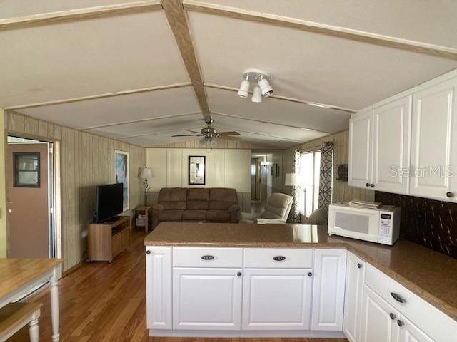 1710 7th Street Southwest, Unit 24 Ruskin, FL 33570 - Photo 12 of 44 a kitchen with a stove a refrigerator and cabinets