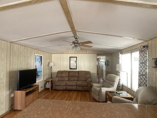 1710 7th Street Southwest, Unit 24 Ruskin, FL 33570 - Photo 14 of 44 a living room with furniture a flat screen tv and a window