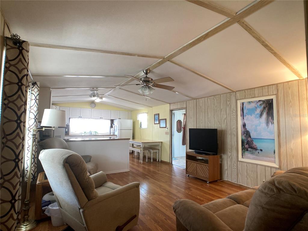 1710 7th Street Southwest, Unit 24 Ruskin, FL 33570 - Photo 15 of 44 a living room with furniture a flat screen tv and kitchen view