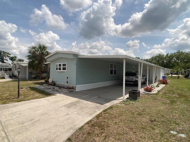 1710 7th Street Southwest, Unit 24 Ruskin, FL 33570 - Photo 3 of 44 a view of a house with backyard and roof