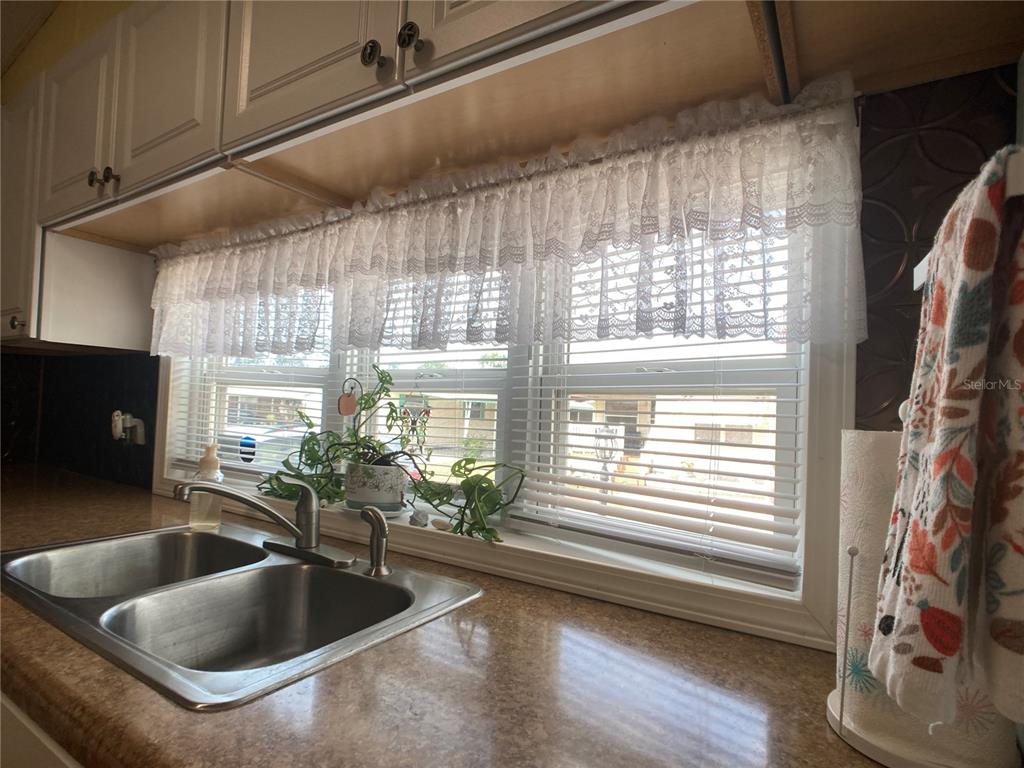 1710 7th Street Southwest, Unit 24 Ruskin, FL 33570 - Photo 10 of 44 a kitchen with granite countertop a sink and a window