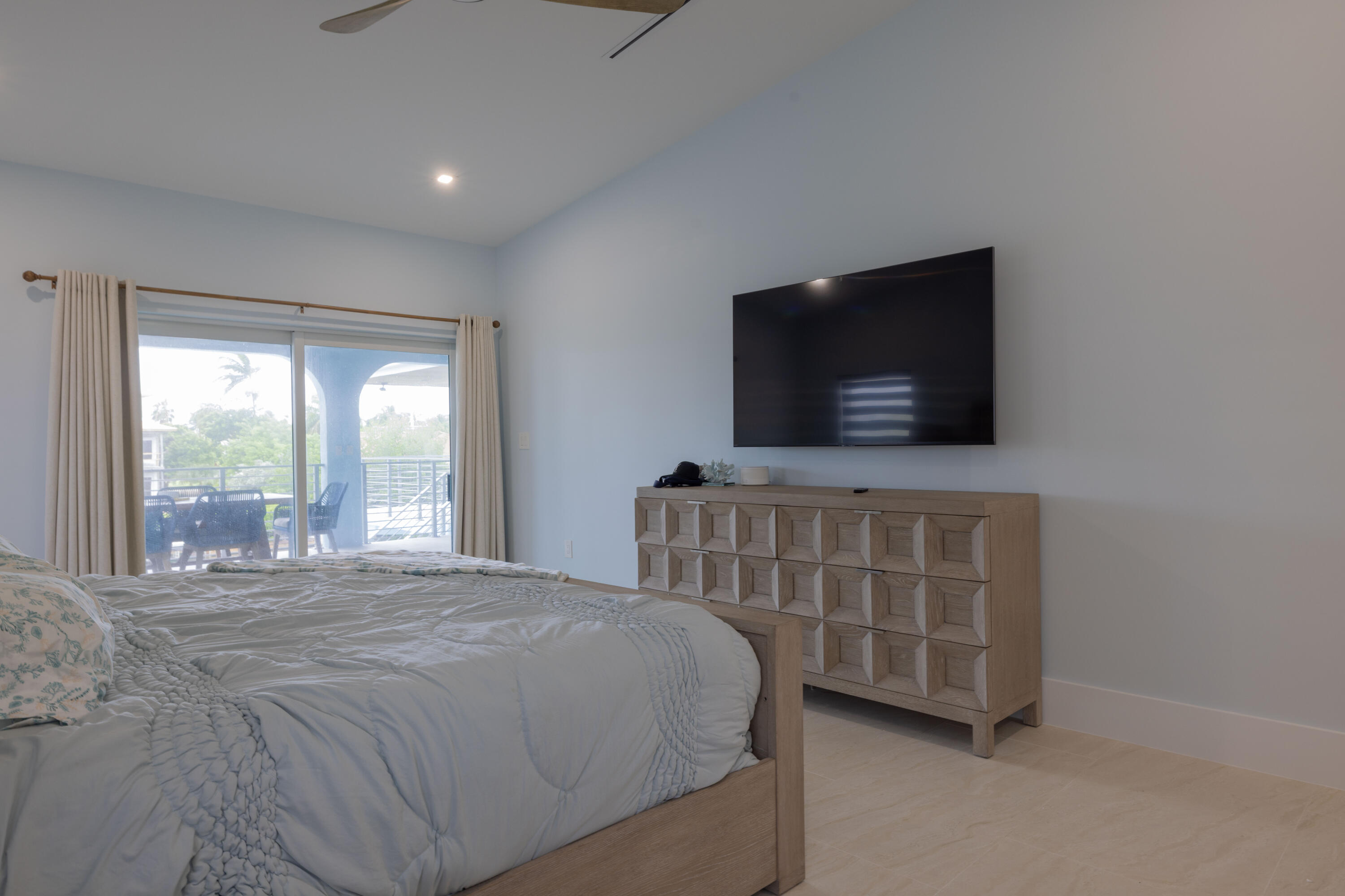 241 12th Street Key Colony Beach, FL 33051 - Photo 17 of 74 a bedroom with a bed and a flat tv screen on the dresser