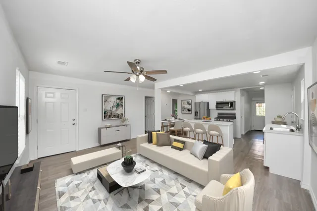 a living room with furniture and a wooden floor