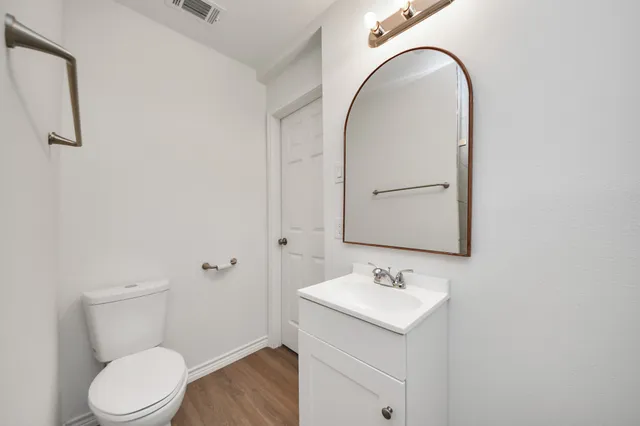 a bathroom with a sink toilet and vanity