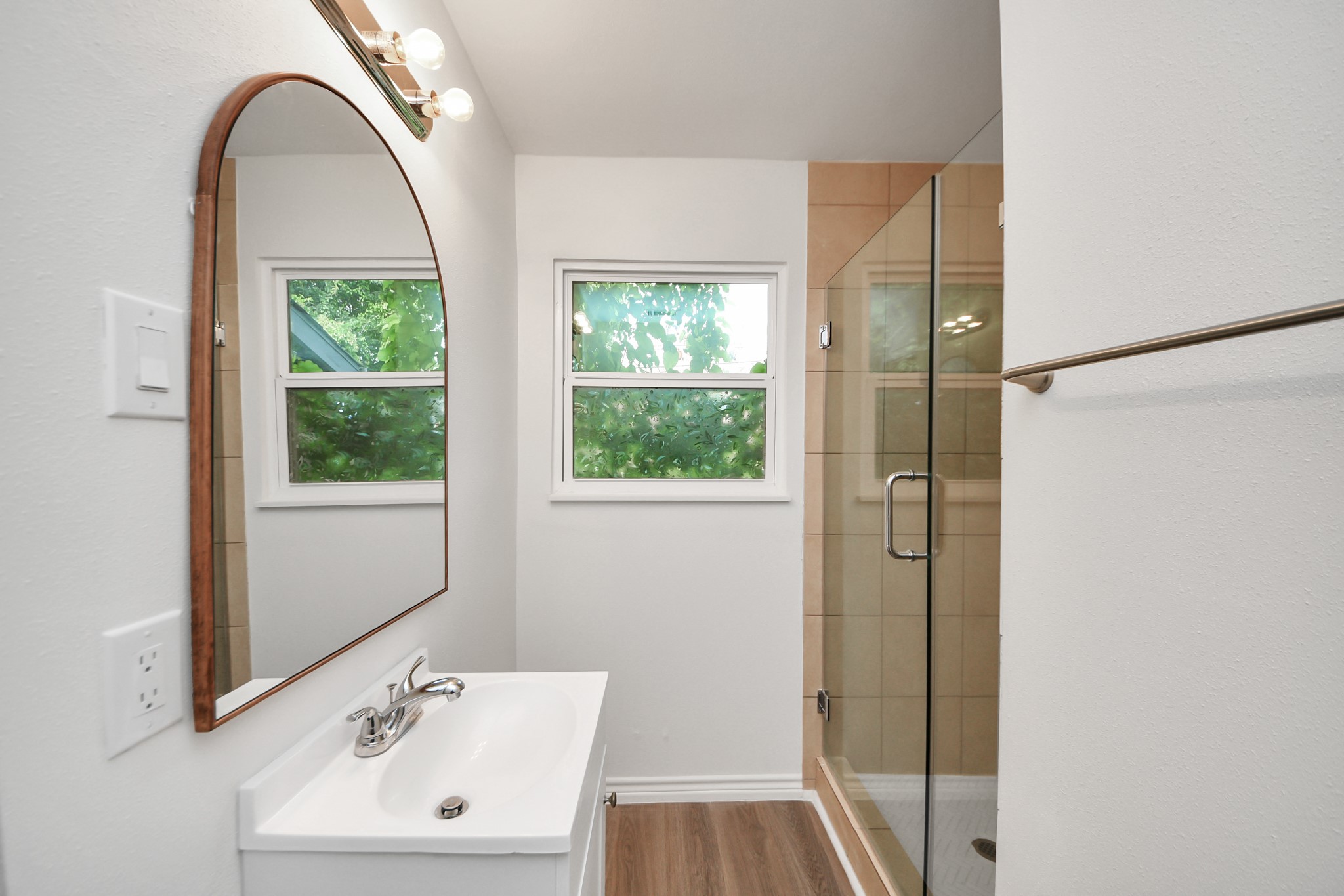 7004 Conley Street Houston, TX 77021 - Photo 13 of 32 a bathroom with a sink a window and a mirror