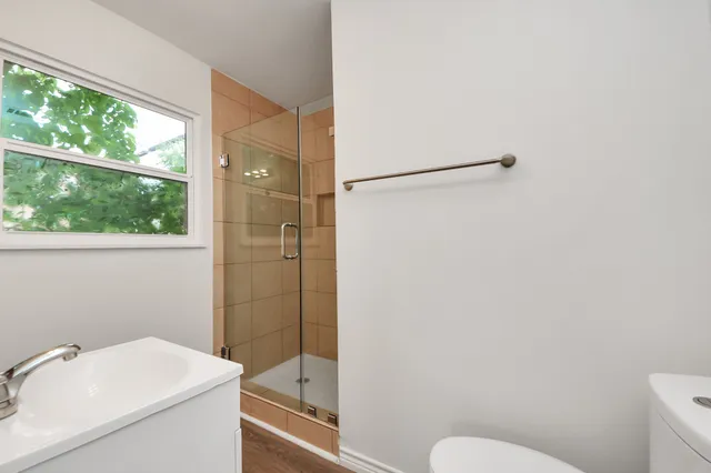 a bathroom with a sink toilet and shower
