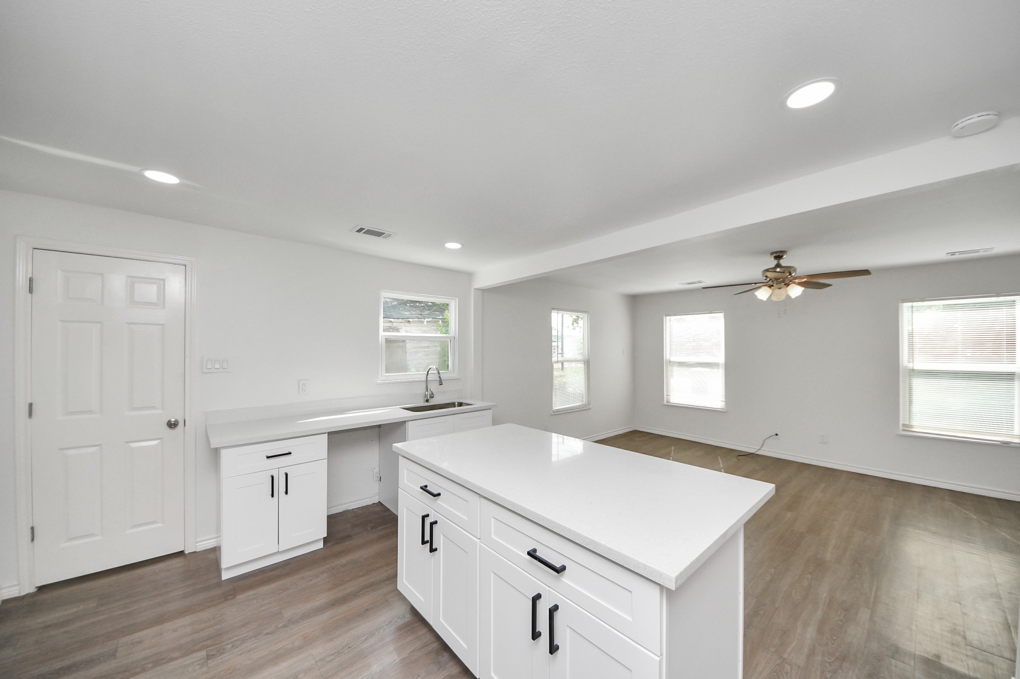 7004 Conley Street Houston, TX 77021 - Photo 19 of 32 a kitchen with a stove a sink and dishwasher with wooden floor