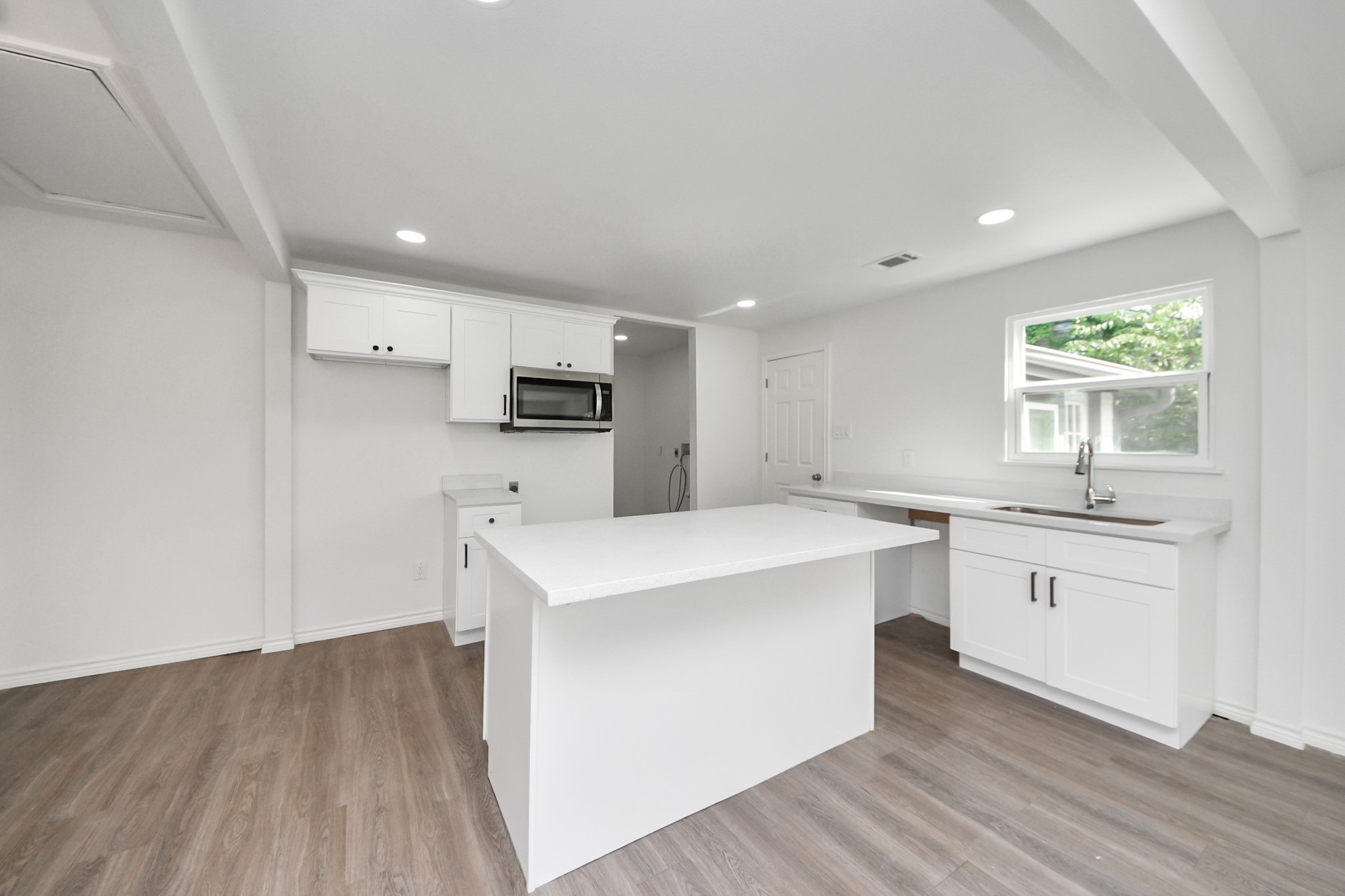 7004 Conley Street Houston, TX 77021 - Photo 24 of 32 a kitchen with white cabinets appliances and sink