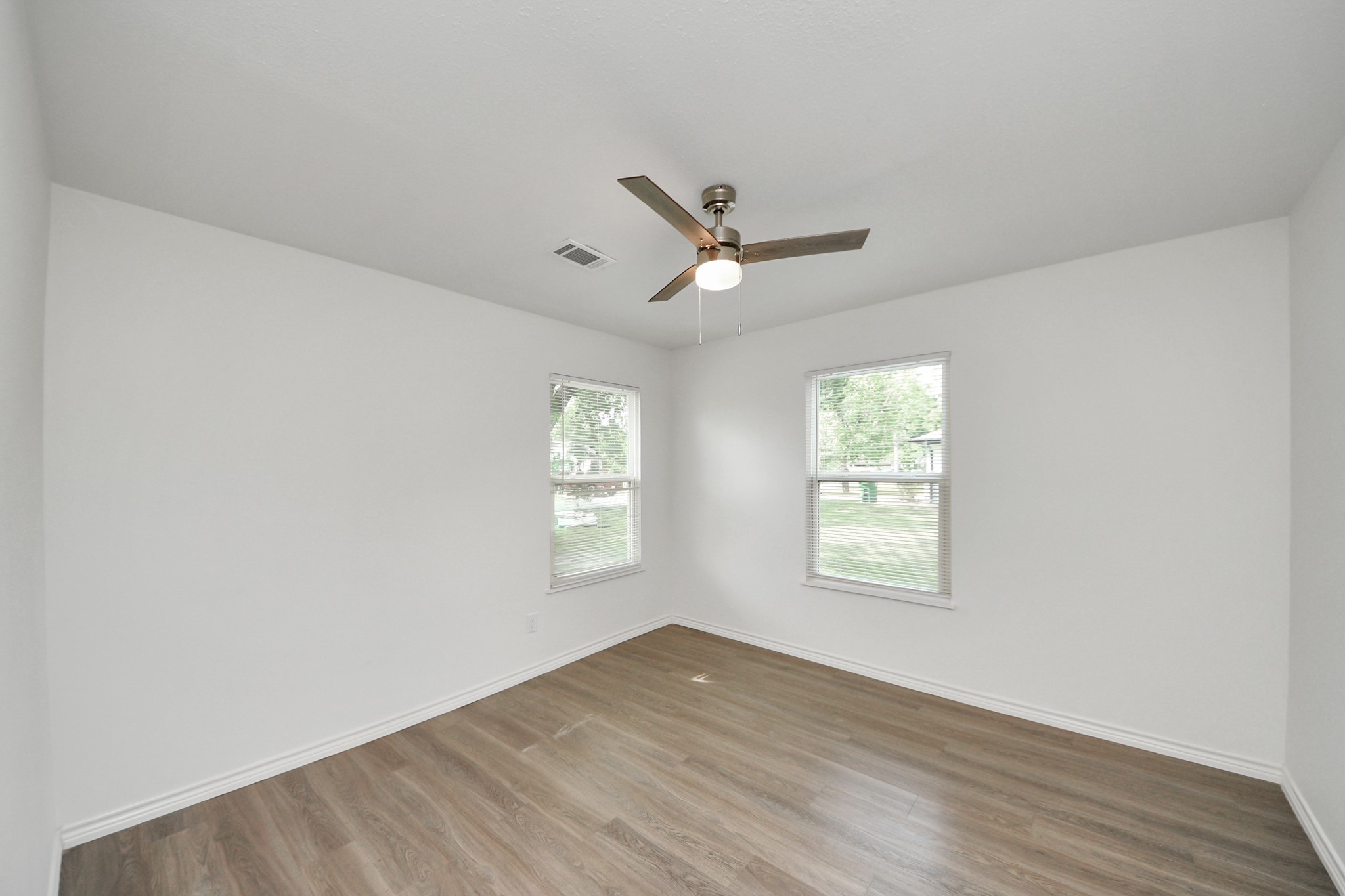 7004 Conley Street Houston, TX 77021 - Photo 27 of 32 a view of an empty room with a window and wooden floor