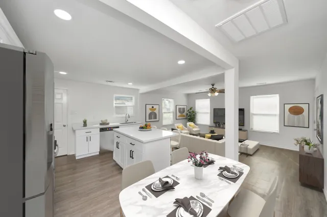 a kitchen with white cabinets and wooden floor