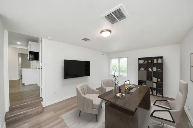a view of a livingroom with furniture and a flat screen tv