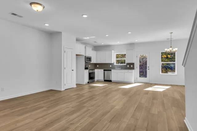 a kitchen with cabinets stainless steel appliances and a counter space