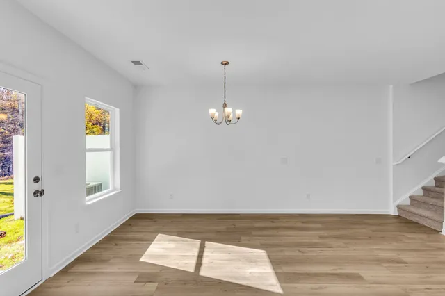 a view of a kitchen with wooden floor and a ceiling fan