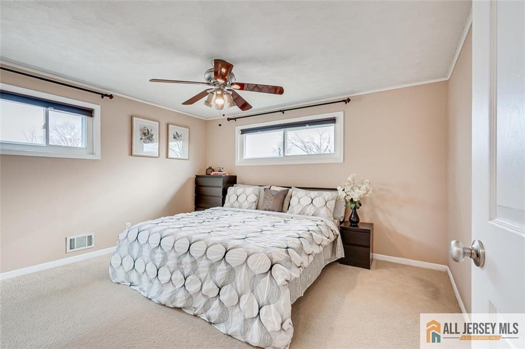 19 Oxford Road East Brunswick, NJ 08816 - Photo 18 of 41 a bedroom with a bed and a chandelier