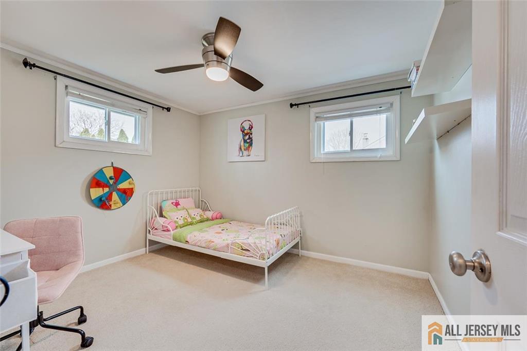19 Oxford Road East Brunswick, NJ 08816 - Photo 20 of 41 a bedroom with a bed and a chandelier