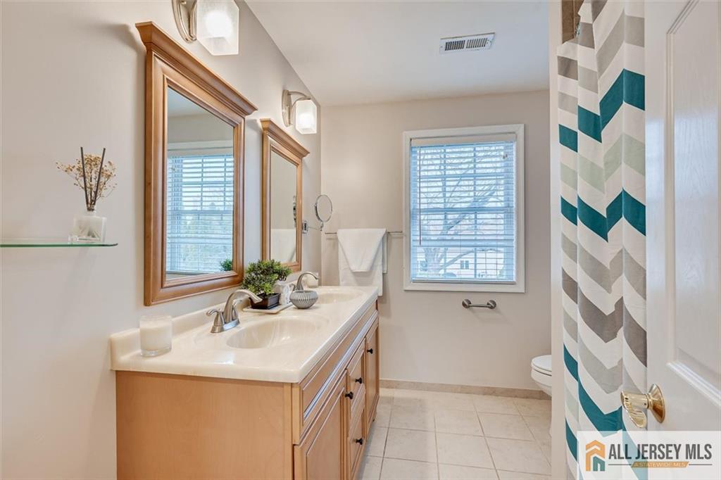 19 Oxford Road East Brunswick, NJ 08816 - Photo 26 of 41 a bathroom with a sink a mirror and a bathtub